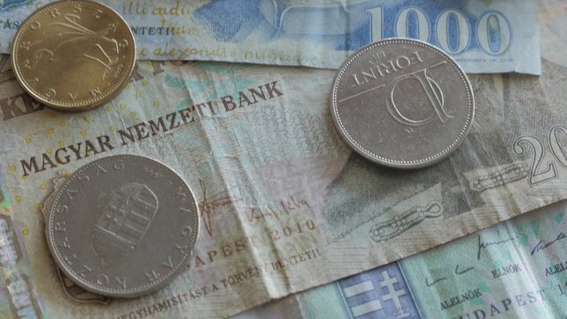 Hungarian paper money and coins forints   banknotes on table arranged slow tilting 4K 2160p UltraHD footage - Slow tilting over various forint banknotes and coins  of Hungary 4K 3840X2160 UHD video