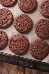 chocolate cookies on the baking sheet close-up. vertical top view 
