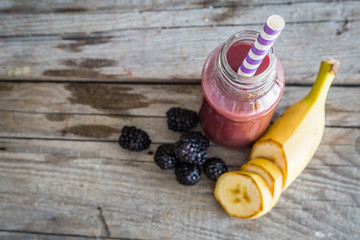 purple smoothie on rustic wood background