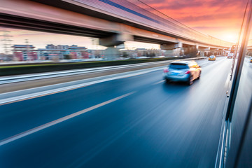 Car driving on freeway at sunset, motion blur