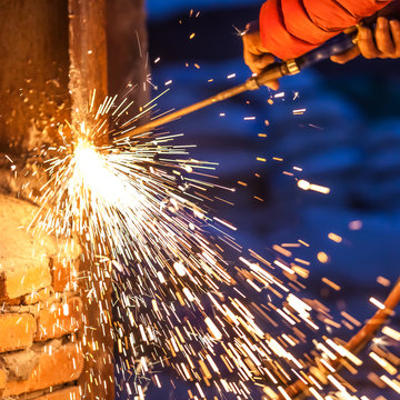 worker cutting steel board using metal torch