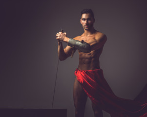 Naked man in a red dress.