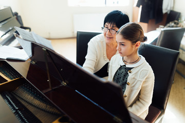  music teacher with the pupil at  lesson piano