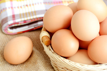 Wicker basket with eggs on a linen tablecloth