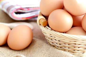Wicker basket with eggs on a linen tablecloth
