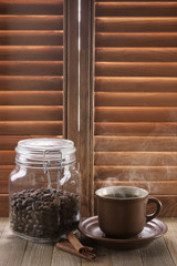 Hot coffee against shutters