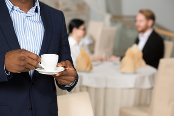 Businessman holding cup of coffee