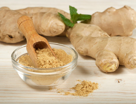 Ginger Root And Powder On Wooden Background