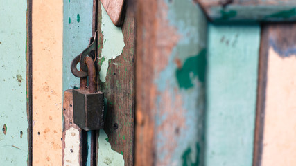 Old key locked of vintage wood.