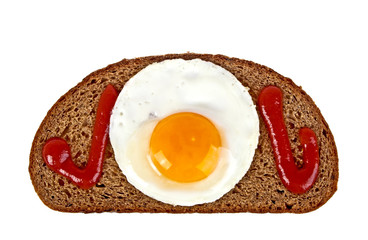 Fried egg, rye bread and ketchup on a white background