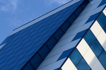 Detail of blue glass building skyscraper and sky, business concept