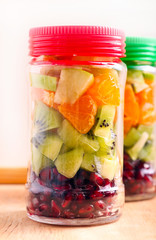 Fruits layered in glass jars