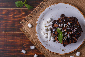Pancakes with marshmallow and chocolate syrup.