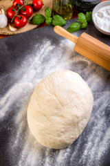 Rolling pizza dough with wooden roller