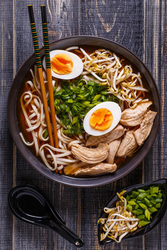 Japanese ramen soup with chicken, egg, chives and sprout.