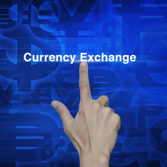 Hand pressing currency exchange word on blue currency background