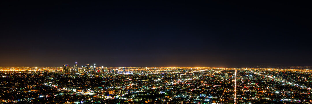 Panorama long exposure night view of Los Angeles downtown and surrounding metropolitan area from Hollywood hills
