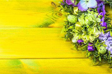 Easter decoration from easter eggs, easter boxwood and flowers.