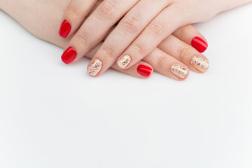 Obraz na płótnie Canvas Woman hands with red and gold manicure