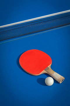 table tennis racket and ball on table