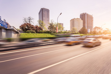 Car driving on road at sunset, motion blur