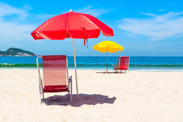 Beach chairs and umbrellas on beach in Rio de Janeiro, Brazil