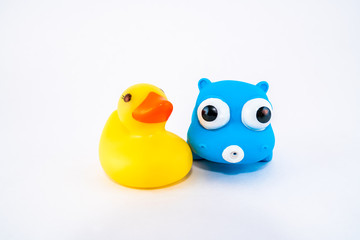 Isolated squeeze bath toys, plastic duck and hippo. 