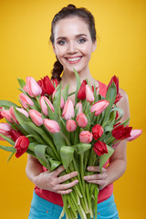 Young beautiful woman studio portrait with tulip flowers