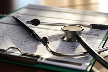 stethoscope medical documents pen
