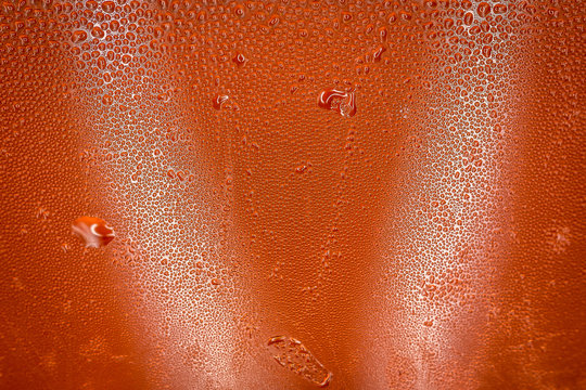 Close up of condensation on a cold glass of lemonade.