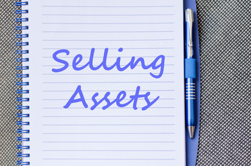 Selling assets write on notebook