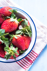 Fresh strawberry in enamel rustic bowl