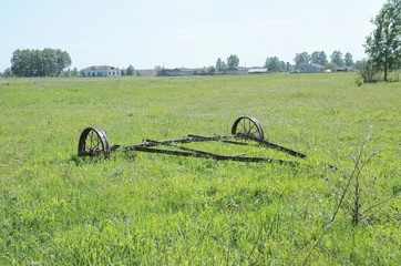 Rusty big old farming plough. Rural view