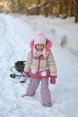 Fototapeta na wymiar girl with sled in winter outdoors