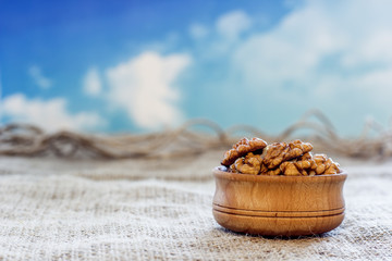 peeled walnuts lie in a wooden bowl
