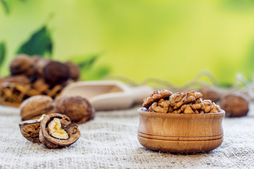 Fototapeta na wymiar peeled walnuts lie in a wooden bowl