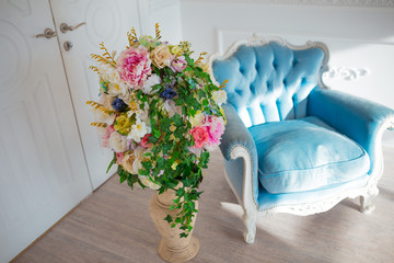 Vintage style chair in classical interior room with sunlight and  flowers