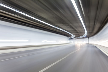 Obraz na płótnie Canvas Abstract speed motion in highway road tunnel, blurred motion tow
