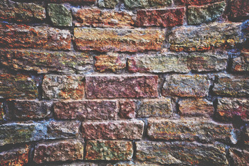 The old brick and stone wall.  Apply color and lighting effects. Vignetting. Matting. Artistic technique.
