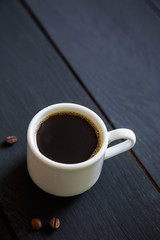 A cup of espresso on a black table