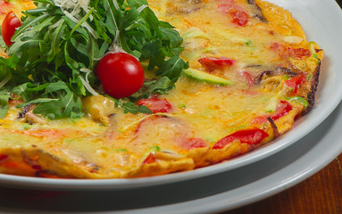 Scrambled eggs with vegetables served on a white plate