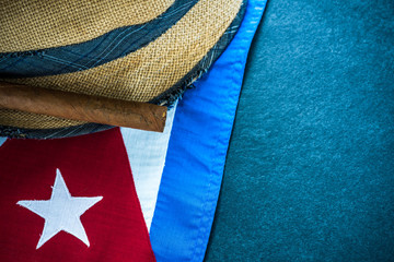 Straw hat with Cuban cigar and Cuban flag.