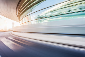 Car driving on road in city background, motion blur