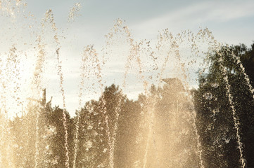 fountain spray sun evening  park