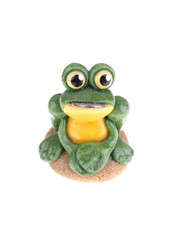 toy frog with a coin in his mouth on a white background