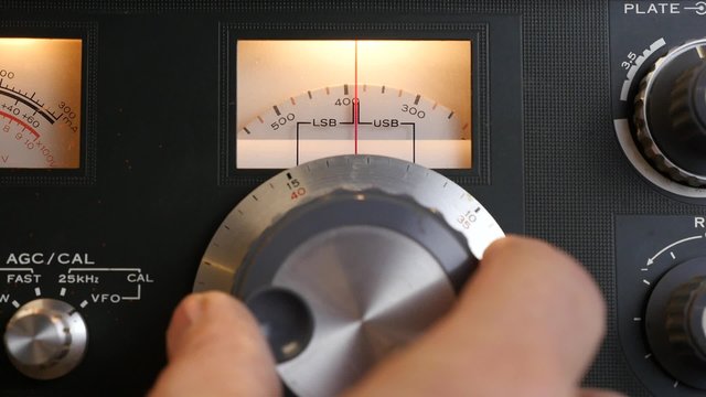 Tuning in a signal on a vintage short wave radio