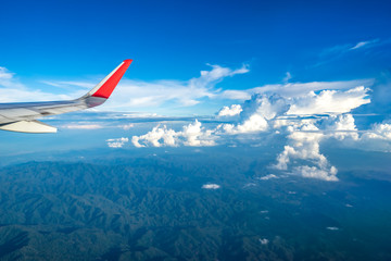Fototapeta premium Clouds and sky as seen through window of an aircraft