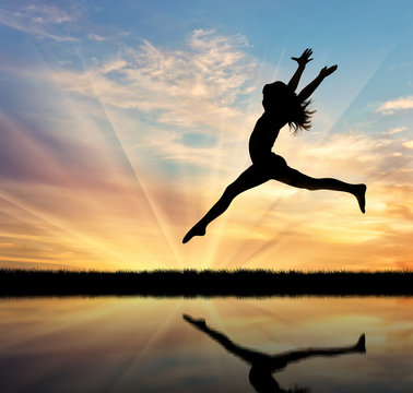 Silhouette of happy woman jumping
