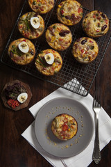 Veggie and bacon mini quiche with quail egg