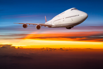 Obraz na płótnie Canvas Airplane in the sky at sunrise